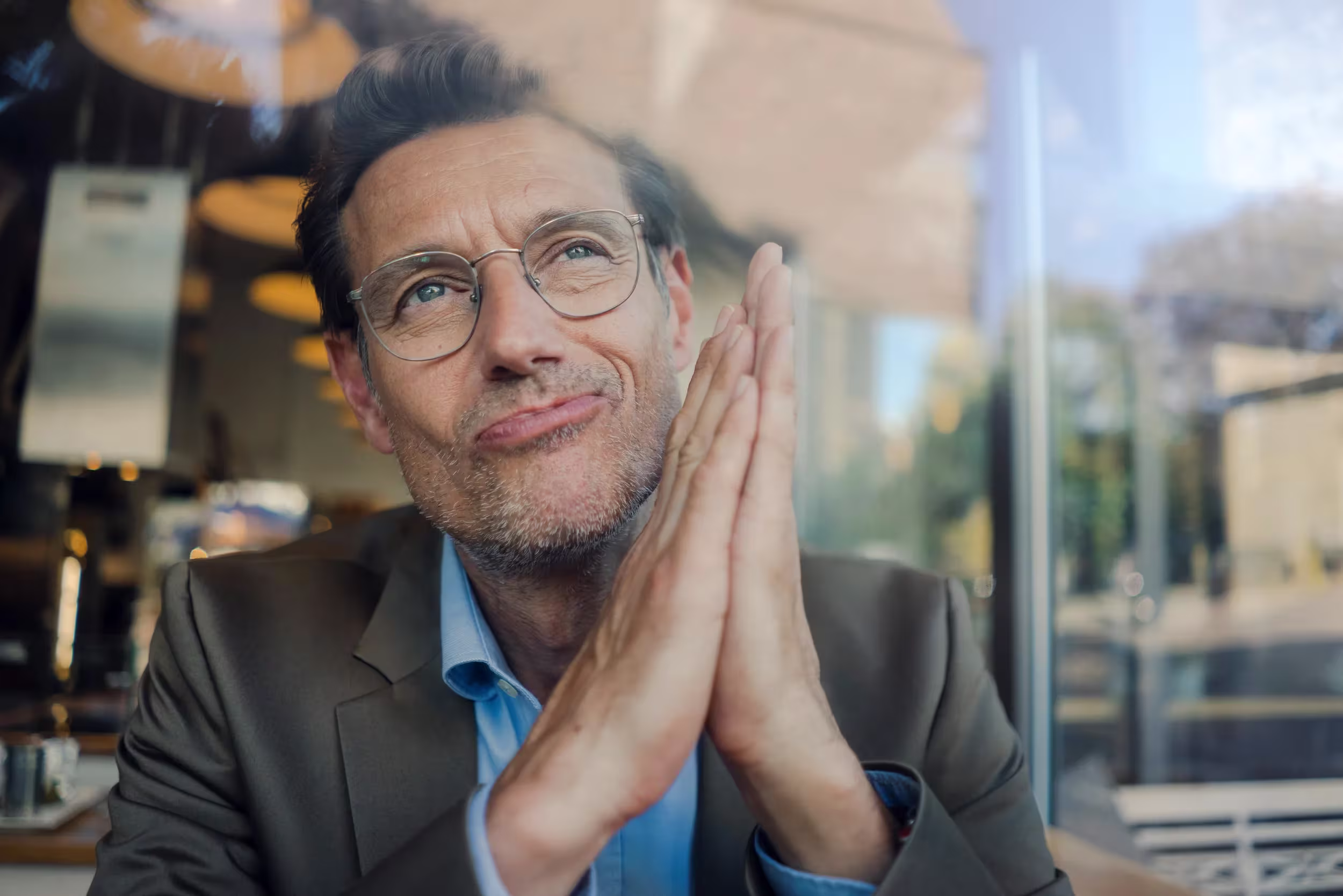 Man with glasses rubbing his hands